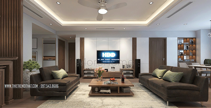 Giữa phòng khách là một bộ sofa bằng nỉ màu socola và một chiếc bàn trà bằng gỗ với thiết kế độc đáo là điểm nhấn đặc biệt cho phòng khách của chung cư.